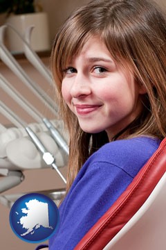 a smiling dental clinic patient - with Alaska icon