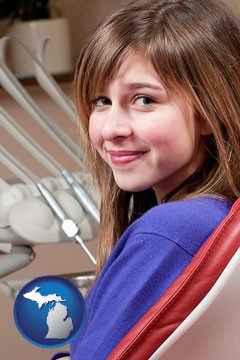 a smiling dental clinic patient - with Michigan icon