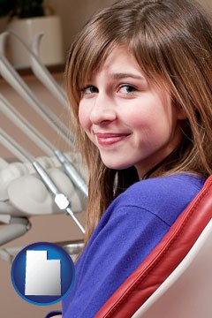 a smiling dental clinic patient - with Utah icon