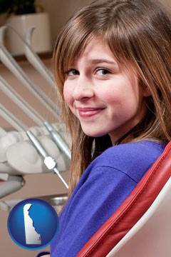 a smiling dental clinic patient - with Delaware icon
